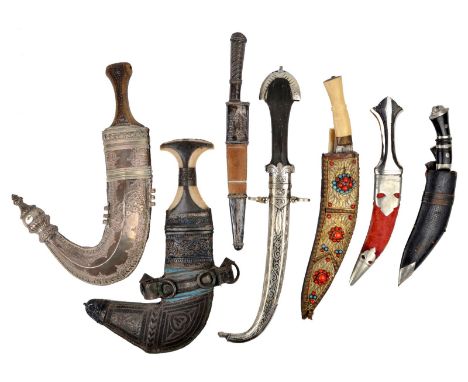 λ A collection of Eastern edged weapons, comprising: a Jambiya, Omani type; the hilt and silver clad scabbard of an Arab Jamb