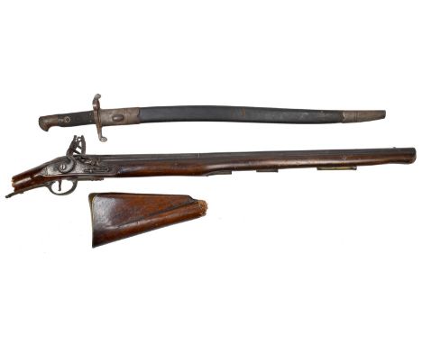 A 16 bore flintlock carbine, two-stage barrel 28 in., lock engraved with flower heads, swan necked cock, full stock with bras