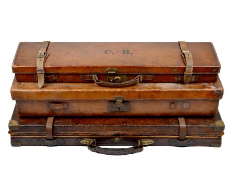 Three vintage sporting gun cases: a Holland and Holland case for a pair of guns, red baize lined interior, leather covered wi