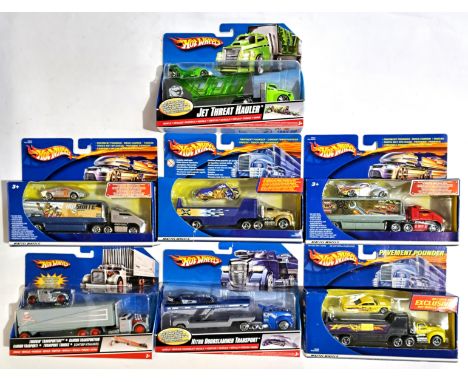 Hot Wheels (Mattel) a boxed group comprising of Truck Transporters to include "Nitro Doorslammer Transport" and similar. Cond
