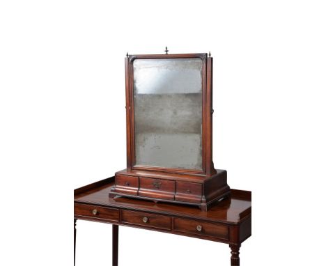 A George II mahogany dressing mirror, circa 1750, the rectangular swing plate with moulded edge supported by moulded tapering