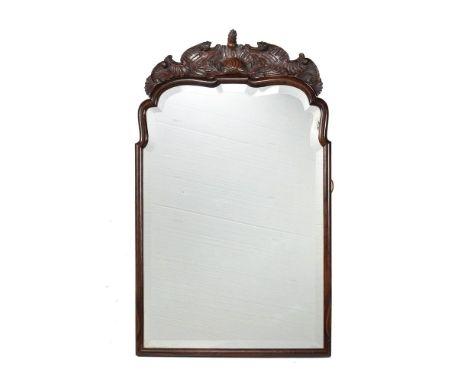 A Continental exotic hardwood wall mirror, possibly Dutch, late 18th century, the carved surmount above the moulded shaped fr