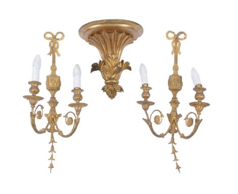 A pair of carved and giltwood twin light wall appliques in 18th century taste, with scrolled foliate arms issuing from ribbon