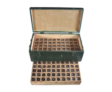 A French cased set of one hundred liqueur glasses, first half 20th century, approximately 8cm high, in a green painted wooden