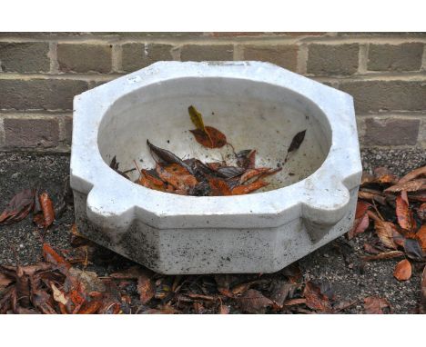 A marble wall basin, 19th century, of elongated octagonal section with protruding lugs to the front and central oval well, 22