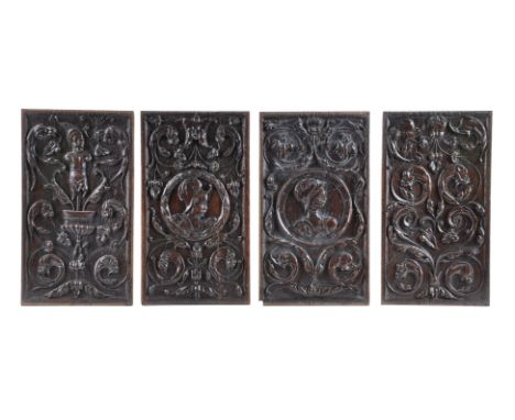 A set of four carved oak recessed relief panels, first half 16th century, probably English, comprising two romaynes with a ma