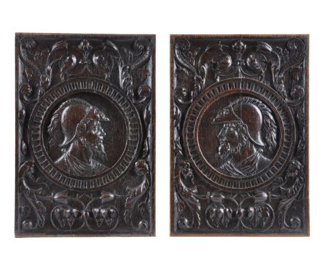 A pair of fine recessed relief carved oak romayne panels, first half 16th century, depicting the heads of soldiers, modelled 