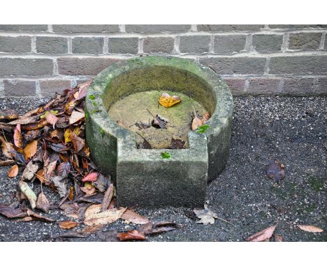 A limestone wall basin, 19th century, of protruding circular form, with central drainage hole, 18cm high, 44cm wide, 51cm dee