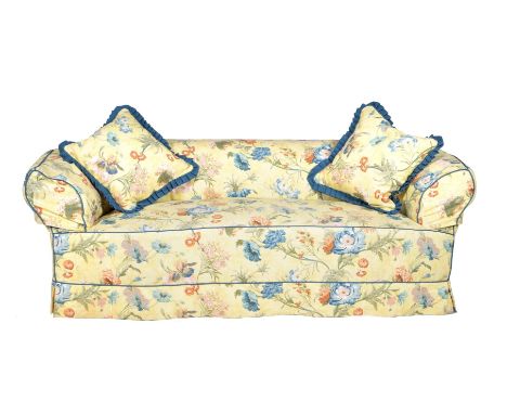 A Victorian mahogany and upholstered sofa, circa 1890, of Chesterfield type and in the manner of Howard &amp; Sons, the casto