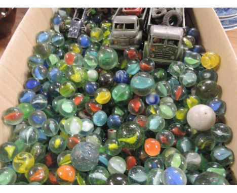 A box of vintage marbles , die cast trucks etc