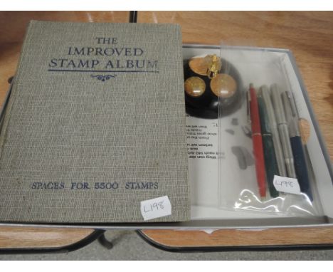 A vintage stamp album, pen stand and fountain pens
