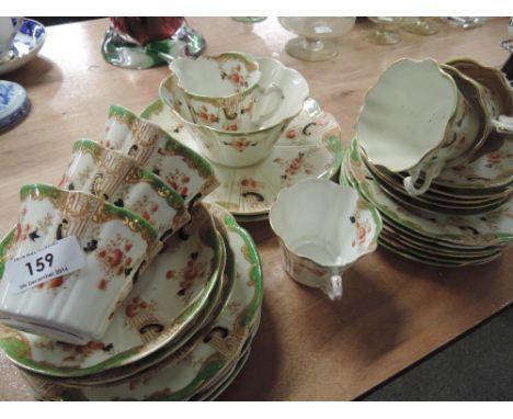 A late Victorian part tea service having green and floral decoration