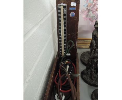 Two vintage stethoscopes and a Baumanometer