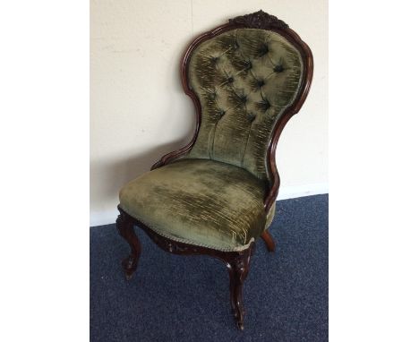 A Victorian button back nursing chair on cabriole legs. Est. £50 - £80.