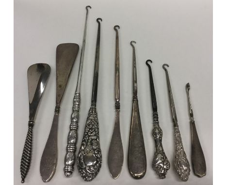 A bag containing numerous silver handled button hooks, shoe horns etc. Various dates and makers. Est. £30 - £40.