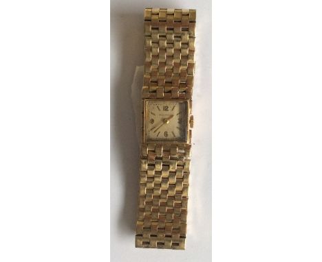 JAEGER LECOULTRE: A lady's 9 carat wristwatch on mesh strap with silvered dial. Approx. 42 grams. Est. £350 - £450.