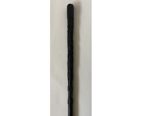 An unusual bog oak tapering walking cane decorated with shamrocks and harp. Est. £50 - £80.