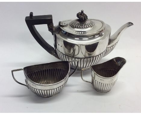 An Edwardian silver three piece tea service. Birmingham. By CH. Approx. 536 grams. Est. £200 - £300.