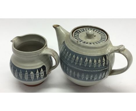 MARIANNE DE TREY: A pottery teapot and matching cream jug. Est. £25 - £35.