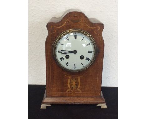  An Edwardian mahogany mantle clock inlaid with decoration. Est. £25 - £35.