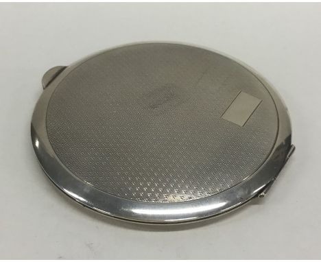 A large silver circular engine turned compact. Birmingham. By BB. Approx. 141 grams. Est. £40 - £60.