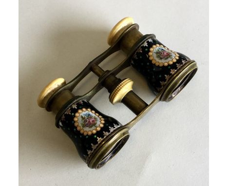 A pair of enamel decorated opera glasses with floral decoration. Est. £20 - £30.