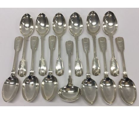 A heavy set of twelve fiddle, thread and shell pattern dessert spoons together with matching ladle. London. By Elkingtons. Ap