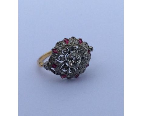 An attractive Edwardian diamond and ruby cluster ring in gold setting. Approx. 6 grams. Est. £800 - £1200. 