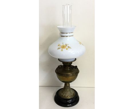 A brass mounted oil lamp on tapering base. Est. £30 - £40.