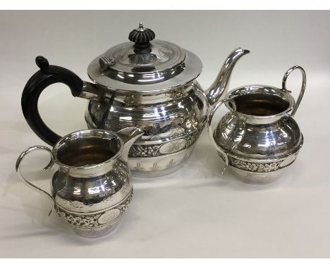 A stylish silver three piece tea service decorated with flowers and leaves. London. By CB&amp;S. Approx. 578 grams. Est. £150