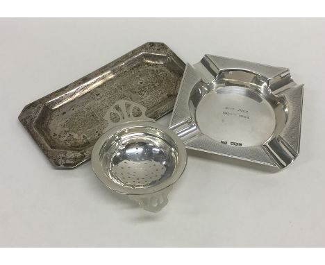 A silver engine turned ashtray together with a pin dish etc. Approx. 140 grams. Est. £30 - £40.