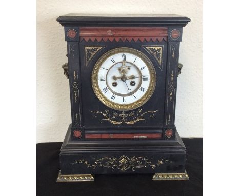 A large slate mantle clock decorated with gilding. Est. £40 - £60.