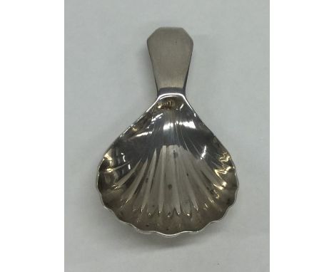 A Georgian silver fluted caddy spoon. London. By SH. Approx. 9 grams. Est. £25 - £35.
