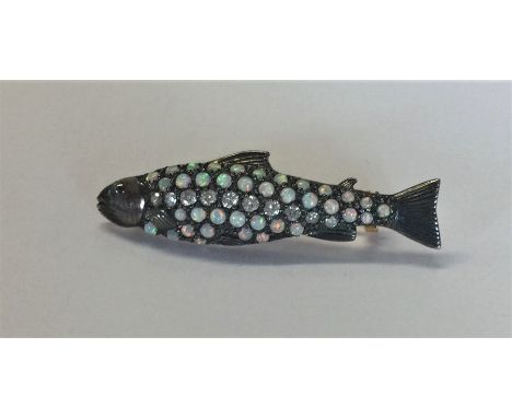 A novelty opal and diamond mounted brooch in the form of a fish. Approx. 5 grams. Est. £80 - £120.