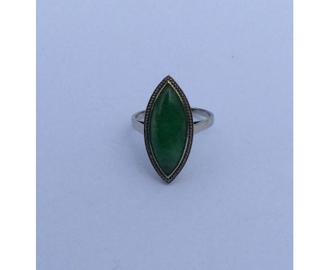 A large jade marquise shaped ring in white gold claw mount. Approx. 4 grams. Est. £450 - £550.