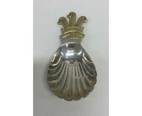 An unusual cast silver and silver gilt caddy spoon with fluted bowl. London. By RB. Approx. 24 grams. Est. £30 - £40.