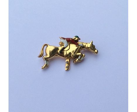 LACLOCHE: An 18 carat gold brooch in the form of a jockey on horseback with enamel decoration. Approx. 8 grams. Est. £1500 - 