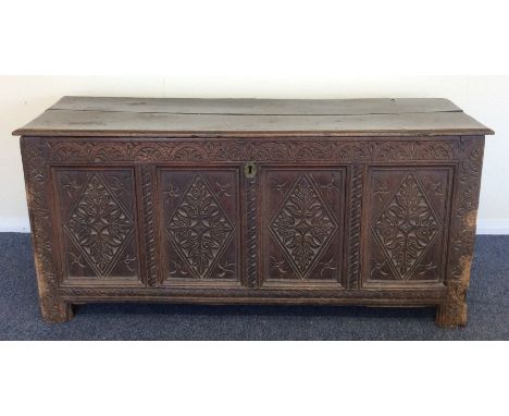 An Antique oak four panel coffer with plank top. Est. £80 - £120.