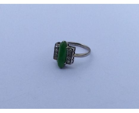 A diamond and jade three row ring in white gold. Approx. 4 grams. Est. £650 - £750.