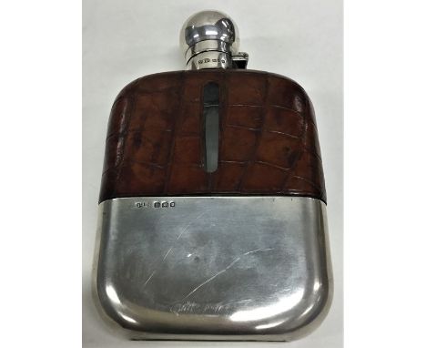 A massive silver and crocodile skin hip flask with hinged top and detachable base. London. By DT&amp;B. Approx. 17 cms high. 