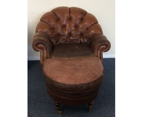 A leather button back armchair together with matching stool. Est. £30 - £50.