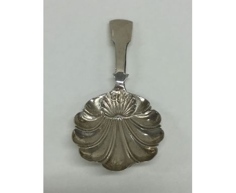 An unusual Georgian silver caddy spoon with fiddle pattern handle. London. By TT. Approx. 9 grams. Est. £25 - £35.