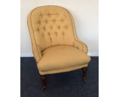A Victorian button back nurse's chair on turned supports. Est. £25 - £35.