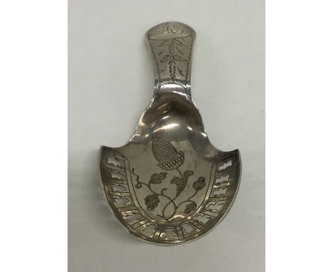 A good Georgian bright cut silver caddy spoon, the bowl pierced with acorns and leaves. Approx. 7 grams. Est. £30 - £50.
