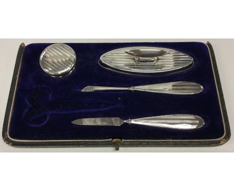 A cased part engine turned silver manicure set. Birmingham. By BA. Est. £10 - £15.