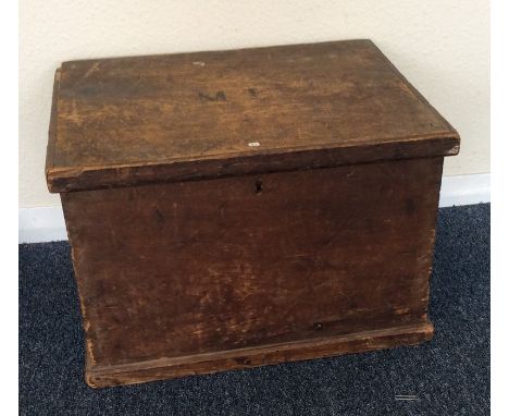 A small pine hinged top trunk. Est. £20 - £30.