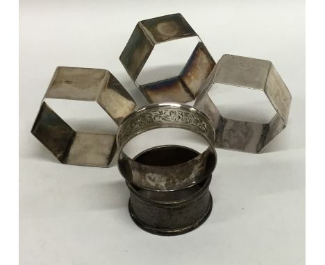 A group of five various silver napkin rings with engine turned decoration. Approx. 82 grams. Est. £25 - £35.