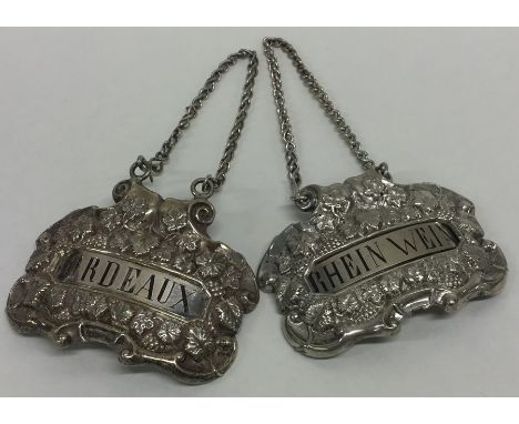 A pair of wine labels with removable enamel and vine decoration. Approx. 41 grams. Est. £30 - £40.