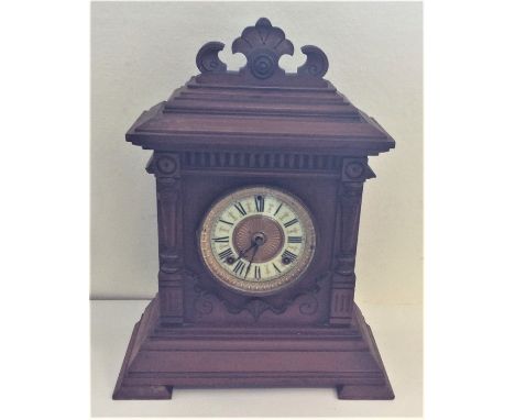 An Edwardian mahogany mantle clock with carved decoration. Est. £15 - £25.