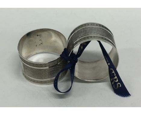 A pair heavy engine turned silver napkin rings. Sheffield. By EV. Approx. 60 grams. Est. £25 - £30.